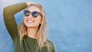 shot of stylish young woman in sunglasses smiling