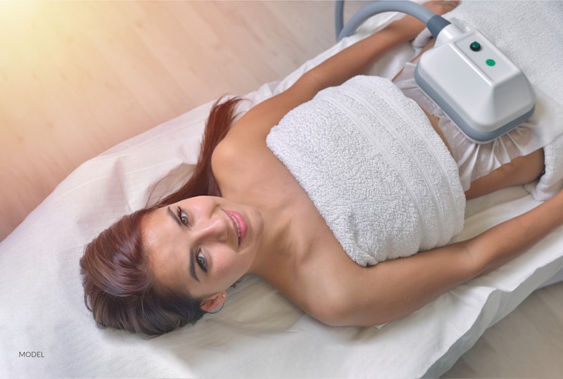 Young woman getting cryolipolysis treatment
