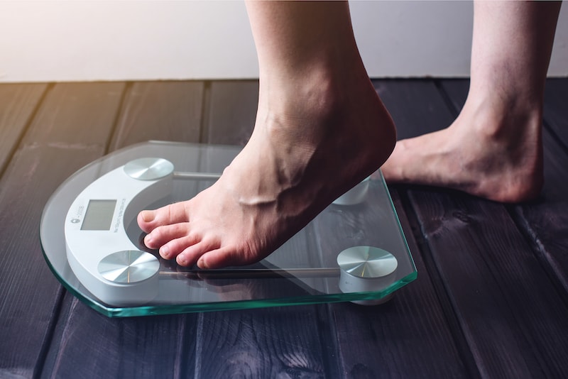 Female feet standing on electronic scales for weight
